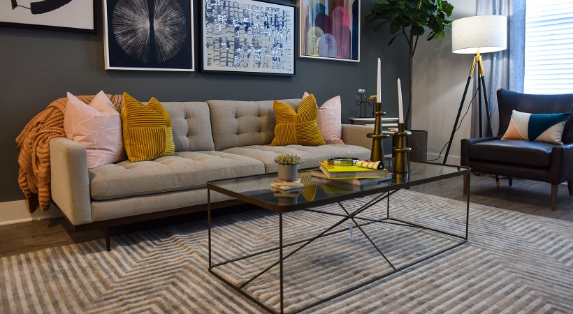 Living Room  Spacious and well lit living room with wood floors and an open floor plan with access to the kitchen.