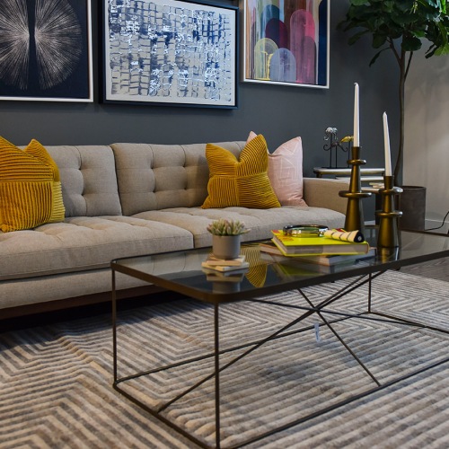 Spacious and well lit living room with wood floors and an open floor plan with access to the kitchen.